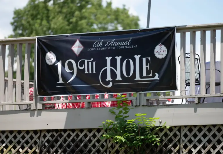 Sponsor banner at a charity golf tournament