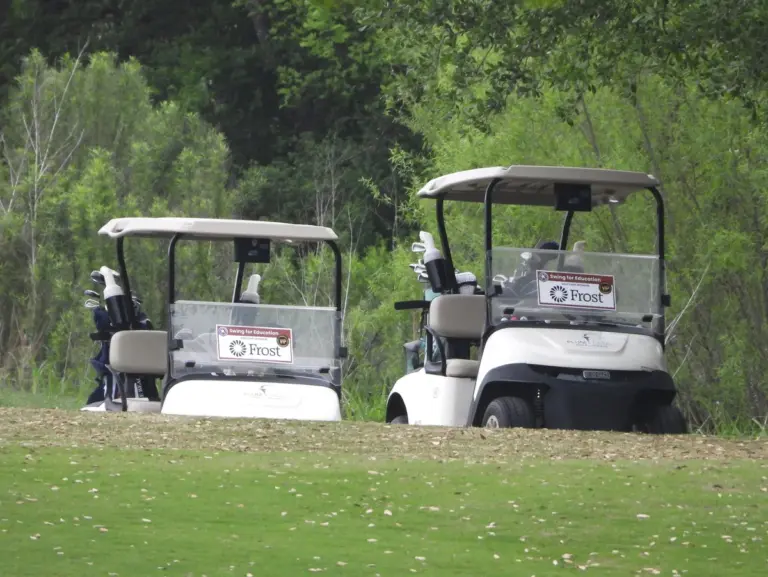 Golf cart sponsor sign at a charity golf tournament