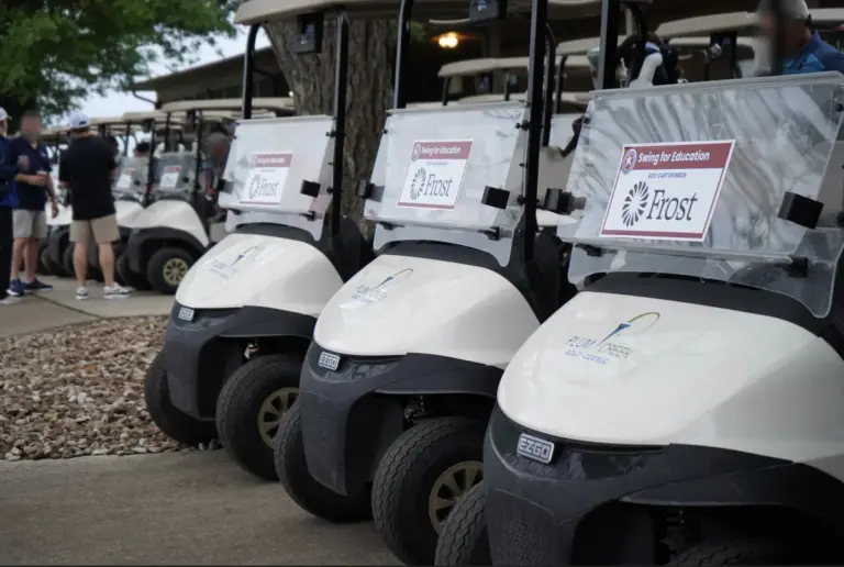 Golf cart sponsor sign at a charity golf tournament
