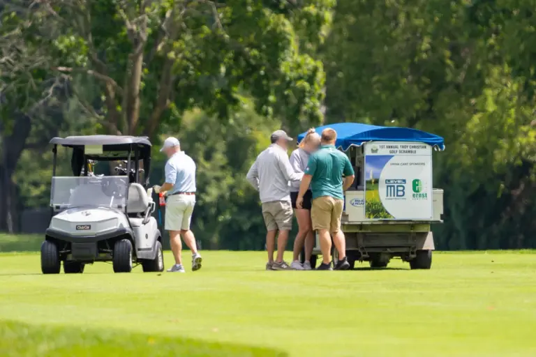 Golf cart sponsor sign at a charity golf tournament